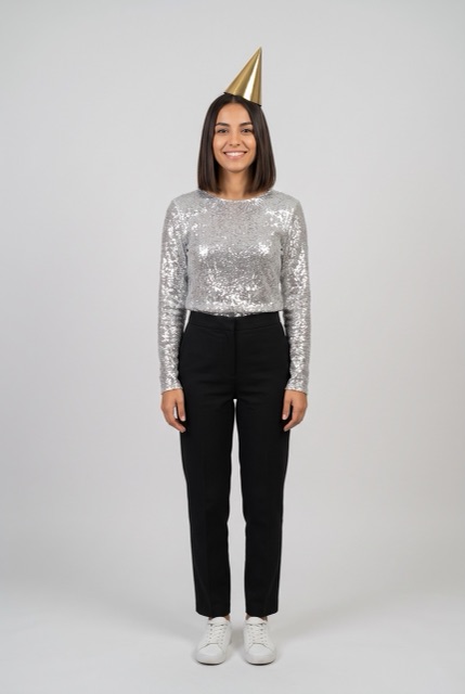 AI-made photo: a woman in a silver sequin top and gold party hat