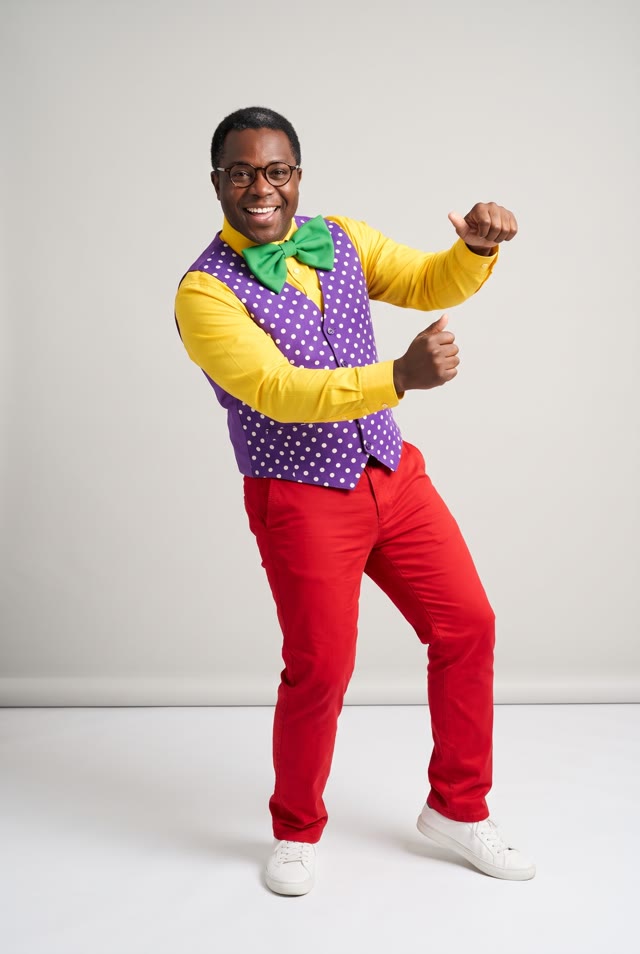 AI-made photo: a man in round glasses, a yellow shirt, a purple polka-dot waistcoat and a green bow tie